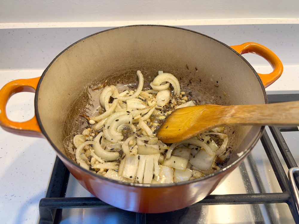 Cooking fennel and cumin seeds in butter, then adding onions and garlic