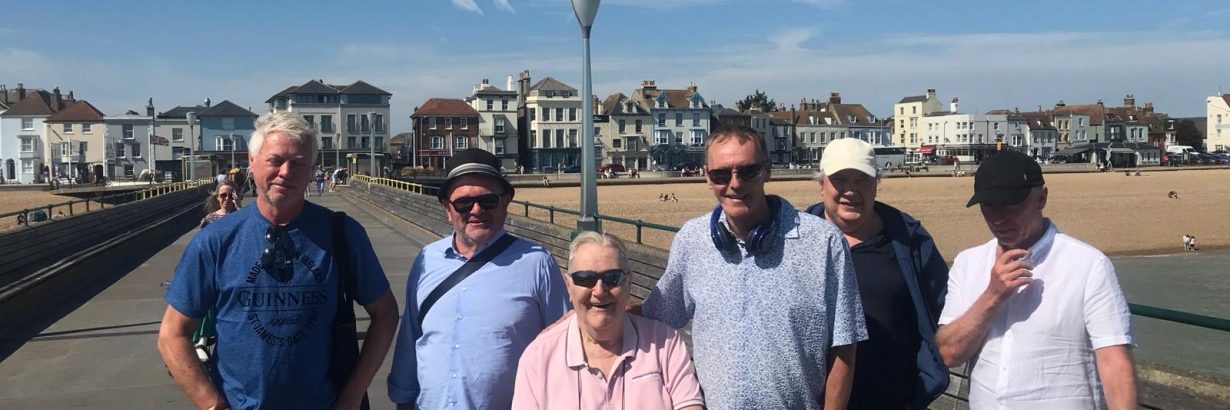 Group pose with beach in the background