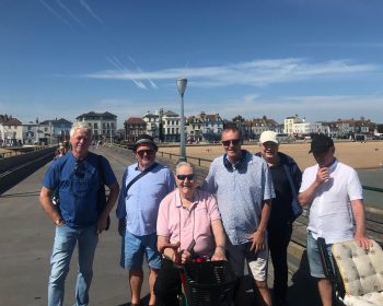 Group pose with beach in the background