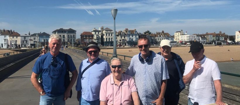 Group pose with beach in the background