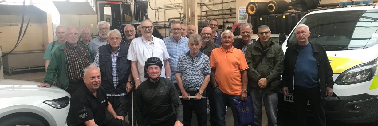 Group poses with police officers and sniffer dog