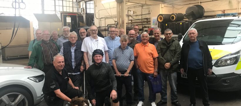 Group poses with police officers and sniffer dog