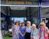 Group pose on Eastbourne Pier in summer clothes.