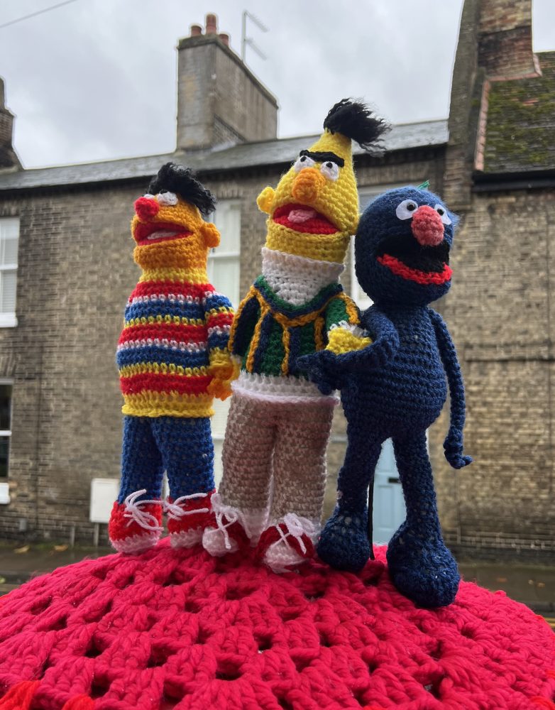 Knitted postbox cover of Muppets